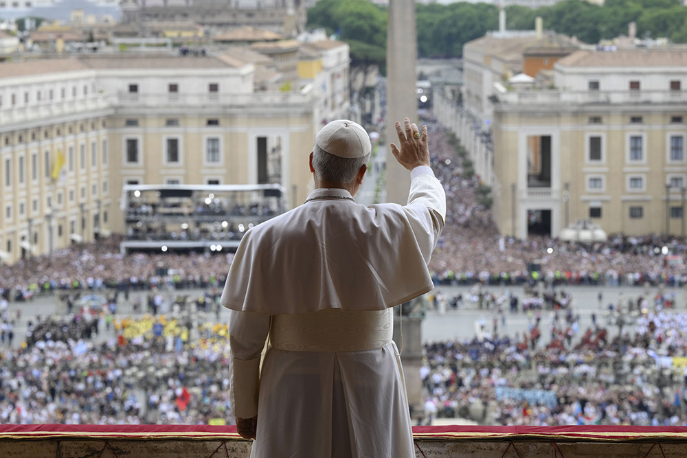 Pope Leo XIV waves to the crowd from the central balcony of St. Peter's Basilica at the Vatican as he leads, for the first time, the midday recitation of the "Regina Coeli" prayer May 11, 2025. (CNS/Vatican Media)
