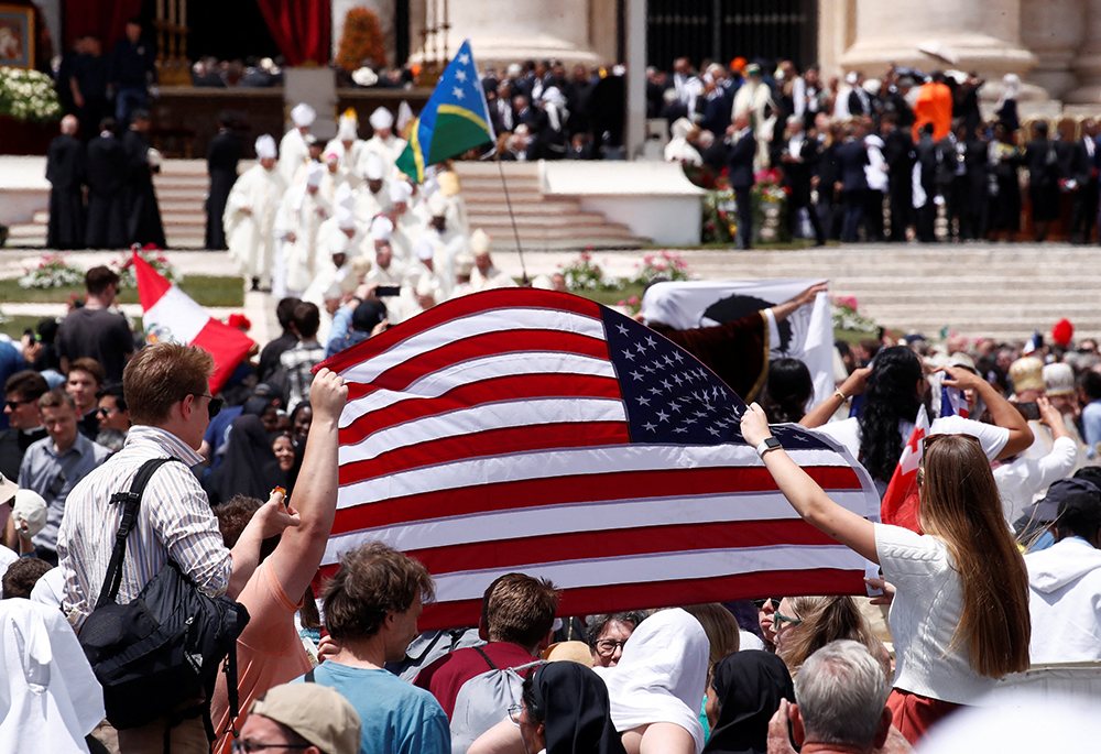Pilgrims hold an American flag after Pope Leo XIV, formerly Cardinal Robert Francis Prevost, celebrated his inauguration Mass May 18, 2025, at the Vatican. He is the first U.S. pope in history. (OSV News/Reuters/Alessandro Garofalo)