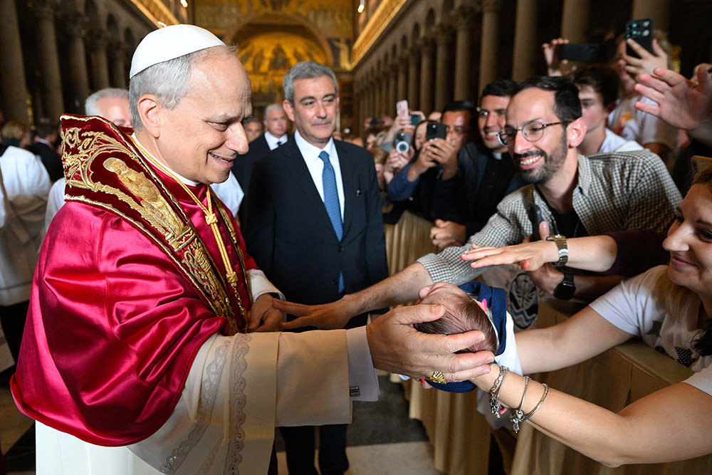 Pope Leo XIV blesses a baby as he departs following a visit to the Basilica of St. Paul Outside the Walls in Rome May 20, 2025. (CNS/Vatican Media)