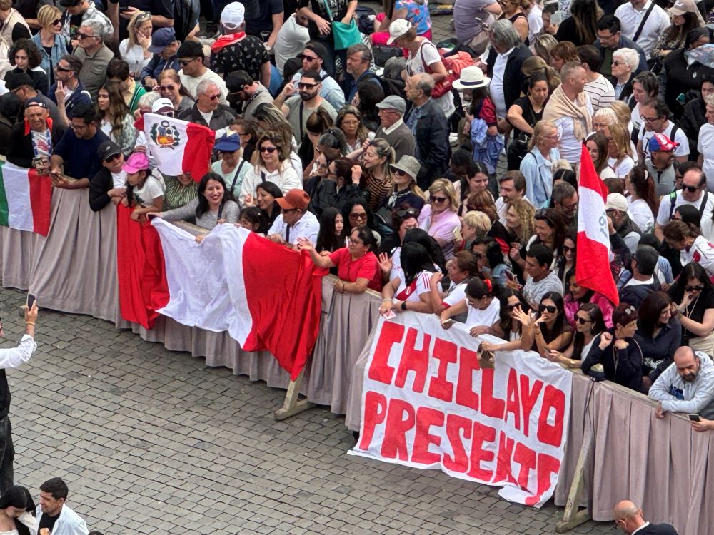 A group of Peruvians at St. Peter's Square waved a flag that said "Chiclayo presente," or "Chiclayo is here," referring to the Diocese of Chiclayo, Peru, where Pope Leo XIV served as priest and bishop, on May 11. (NCR photo/Rhina Guidos)