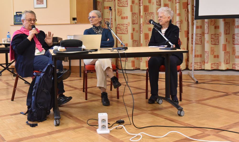 Three people sit at table during meeting of members of the Congregation of Our Lady of Charity of the Good Shepherd and lay members. 