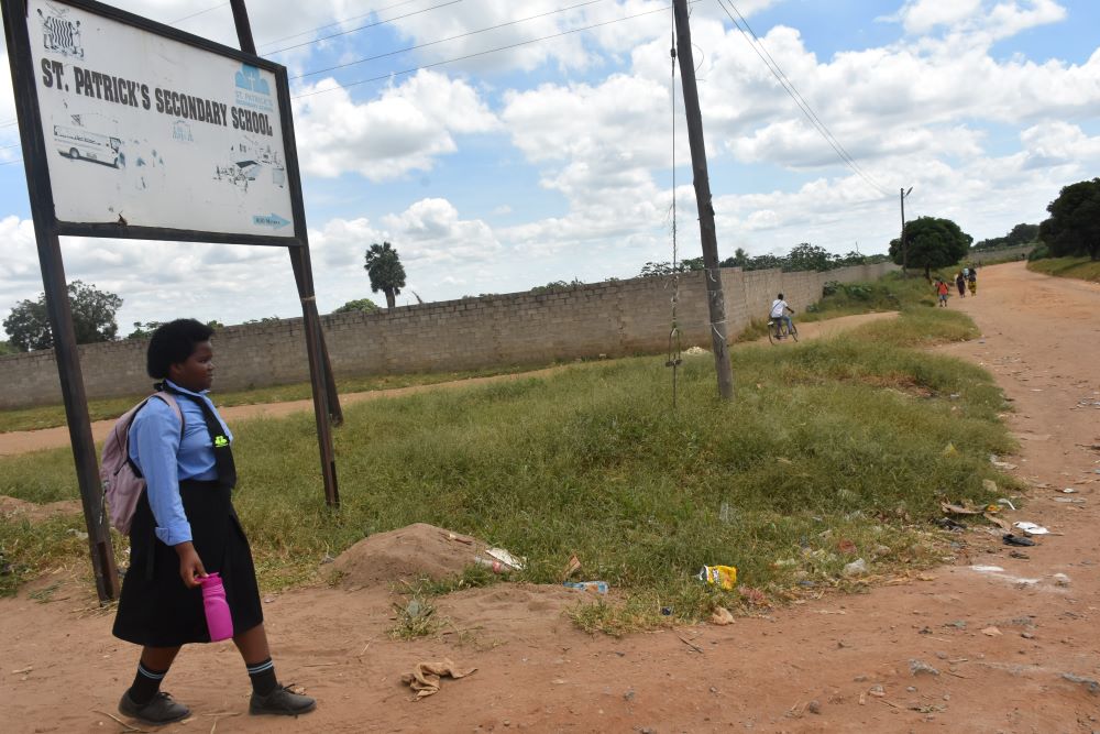 A girl walks to St. Patrick's Secondary School.