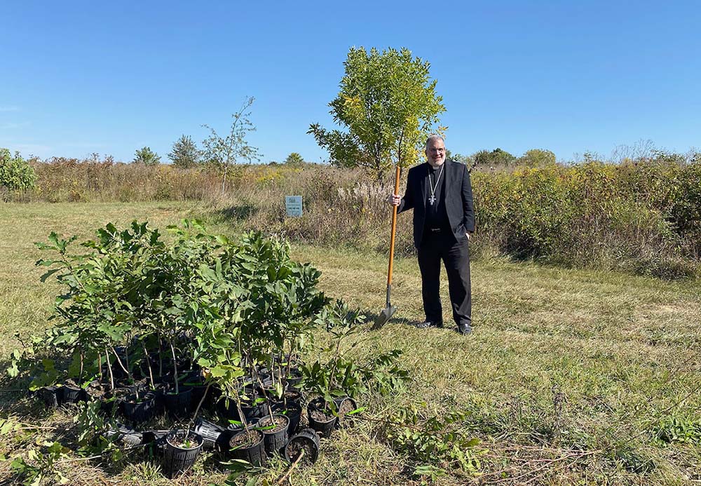 Bishop John Stowe of Lexington, Kentucky, stands beside a newly planted tree in Hisle Park. In September 2023, the diocese partnered with Green Forest Work on a tree planting day to celebrate the Season of Creation, with 300 new saplings placed in the ground. (Kevin Steele)