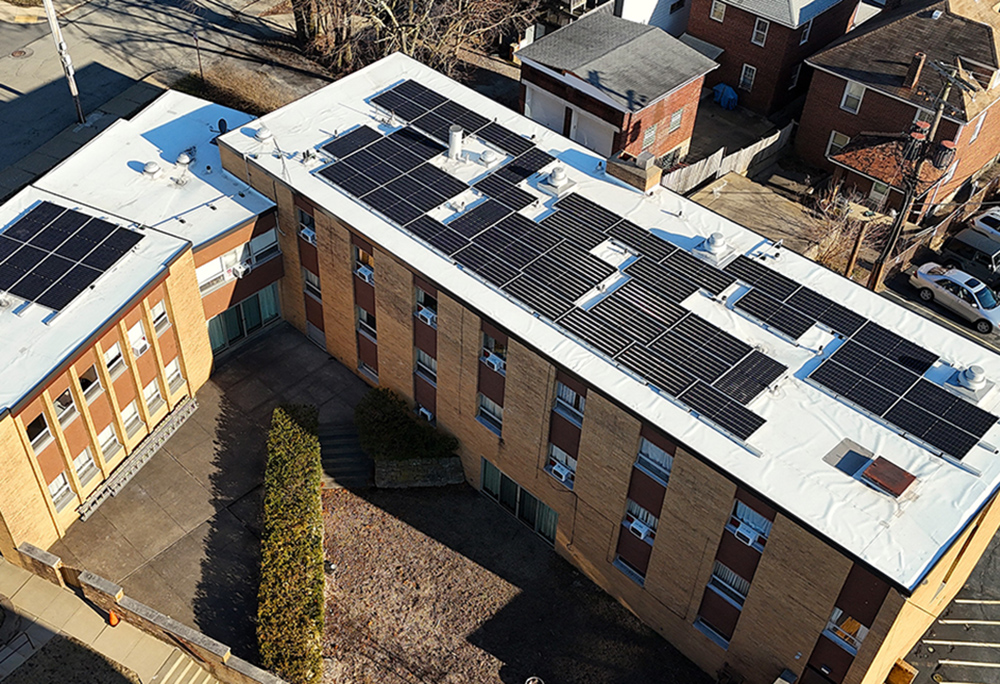 Solar panels are seen on the roof of St. Catherine of Siena Church's rectory buildings in Pittsburgh. More than 170 panels were installed on the roofs of the school, church and rectory buildings. Installation was completed March 4. (Theresa Doerfler)