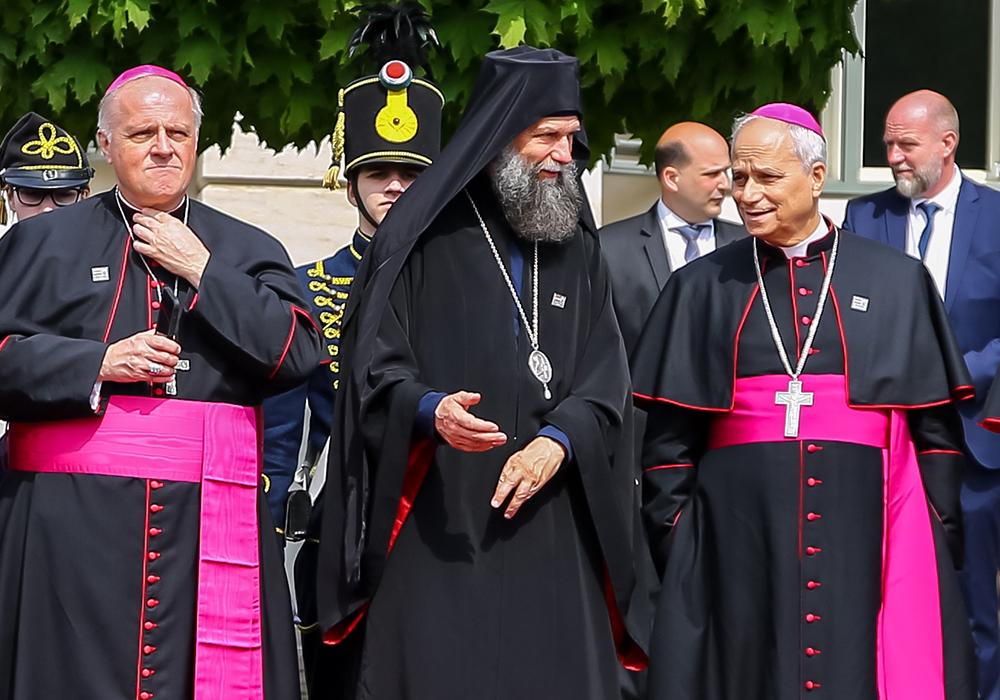 Metropolitan Archbishop Fulop Kocsis of Hajdudorog, Hungary, center, speaks with then-Archbishop Robert Francis Prevost, prefect of the Dicastery for Bishops, as they await Pope Francis' arrival at the Buda Castle in Budapest on April 28, 2023, during his visit to Hungary. Archbishop Michael Wallace Banach, apostolic nuncio to Hungary, stands at the left. Prevost was named a cardinal in 2023 and was elected pope May 8, 2025. (Courtesy of Magyar Kurir/Attila Lambert)