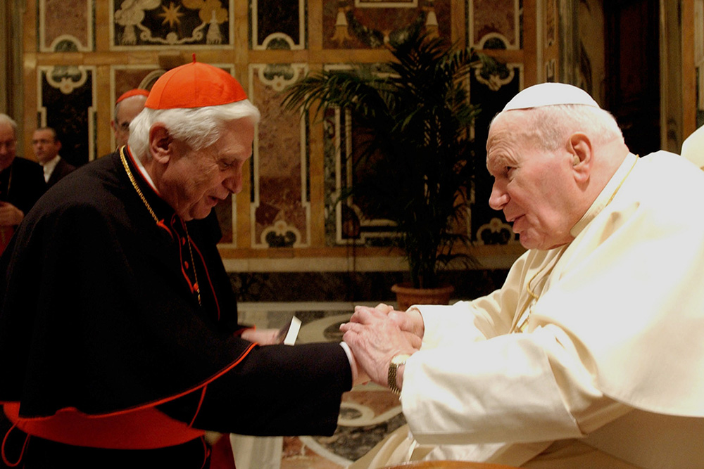 Cardinal Joseph Ratzinger, who later became Pope Benedict XVI, greets St. John Paul II during a 2004 ceremony at the Vatican. In 1981, St. John Paul named Cardinal Ratzinger head of the Congregation for the Doctrine of the Faith. (CNS file)