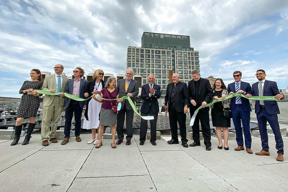 Bishop Nicholas DiMarzio of Brooklyn, N.Y., completes the honors at a solar panel ribbon-cutting ceremony for the new Laudato Si Corporation June 10, 2021. The green initiative was launched to generate power with arrays of solar panels atop residential buildings operated by Catholic Charities of Brooklyn and Queens. (CNS/The Tablet/Bill Miller)