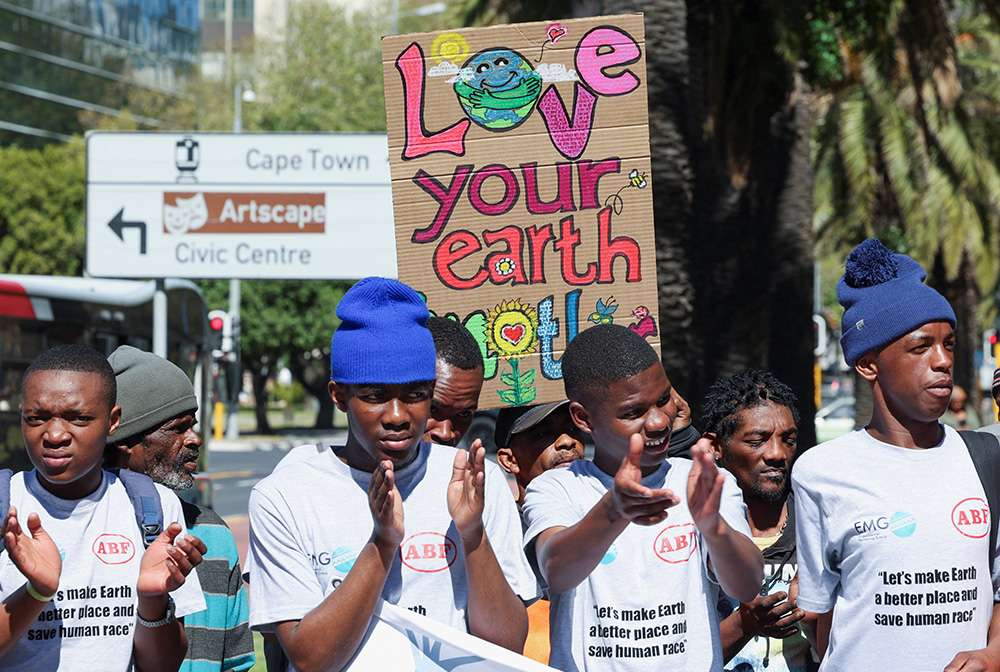A climate activist holds a placard as demonstrators in South Africa gather outside the Cape Town International Convention Center Sept. 13, 2023, during the Southern Africa Oil and Gas Conference to call for climate justice resistance against oil and gas corporations and an end to fossil fuels. (OSV News/Reuters/Esa Alexander)
