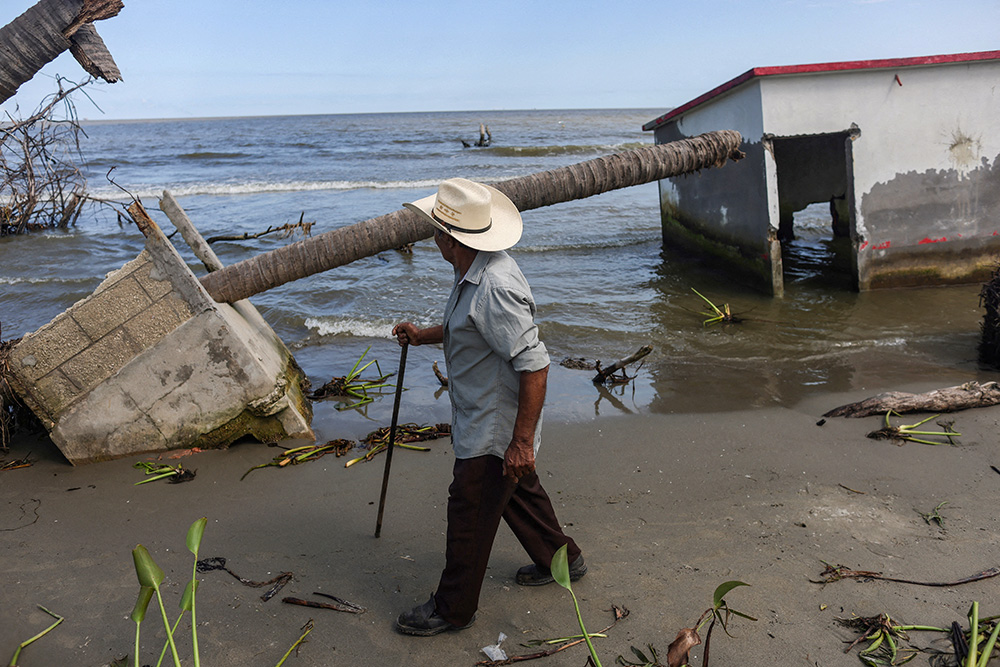Antonio Mayoral, 76, walks past the place where his house once stood in El Bosque, Mexico, Nov. 7, 2022, amid rising sea levels that are destroying homes built on the shoreline and forcing villagers to relocate. (OSV News/Reuters/Gustavo Graf)