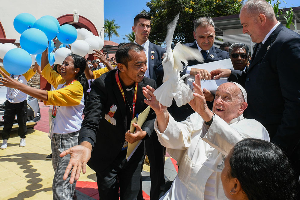 Pope Francis releases a dove after a meeting with young people at a convention center in Dili, Timor-Leste, Sept. 11, 2024. (CNS/Vatican Media)