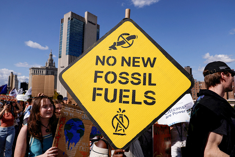 Demonstrators march across the Brooklyn Bridge in New York City Sept. 20, 2024, to call for an end to the era of fossil fuels (OSV News/Reuters/Shannon Stapleton)