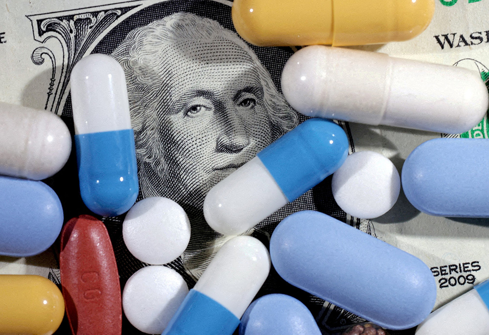 A U.S. dollar bill and medicines are seen in this illustration, taken June 27, 2024. (OSV News/Reuters/Dado Ruvic)