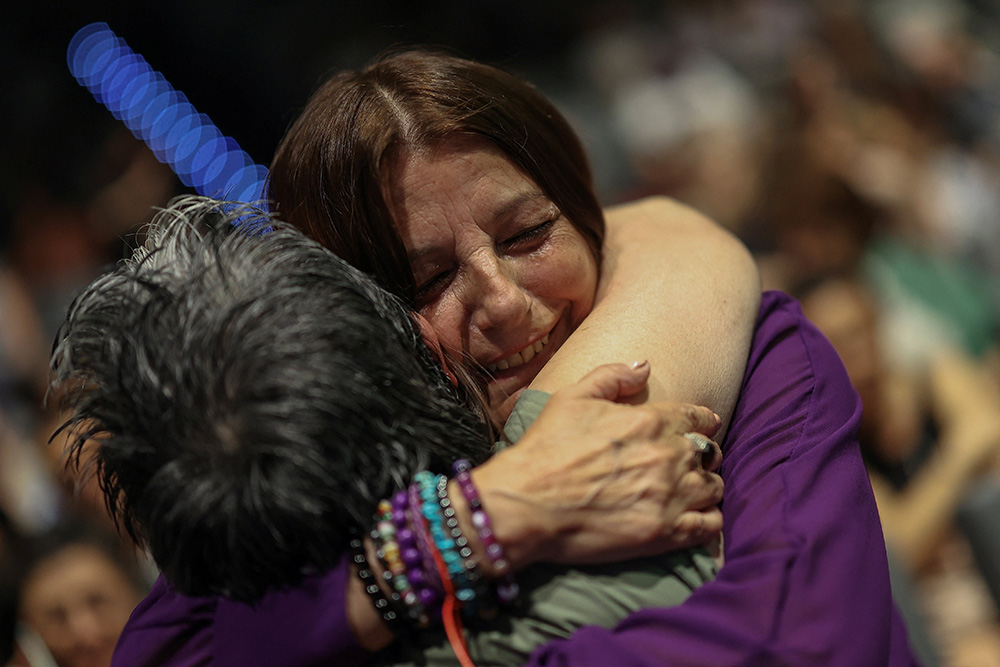 Consuelo Garcia del Cid, 66, a survivor and advocate for the cause, hugs an assistant before a ceremony in Madrid June 9, 2025, by the Spanish Confederation of Religious Entities to apologize to the survivors of Catholic moral rehabilitation institutes in Spain, where thousands of women and girls suffered harsh treatment during Francisco Franco's dictatorship. (OSV News/Reuters/Juan Medina)