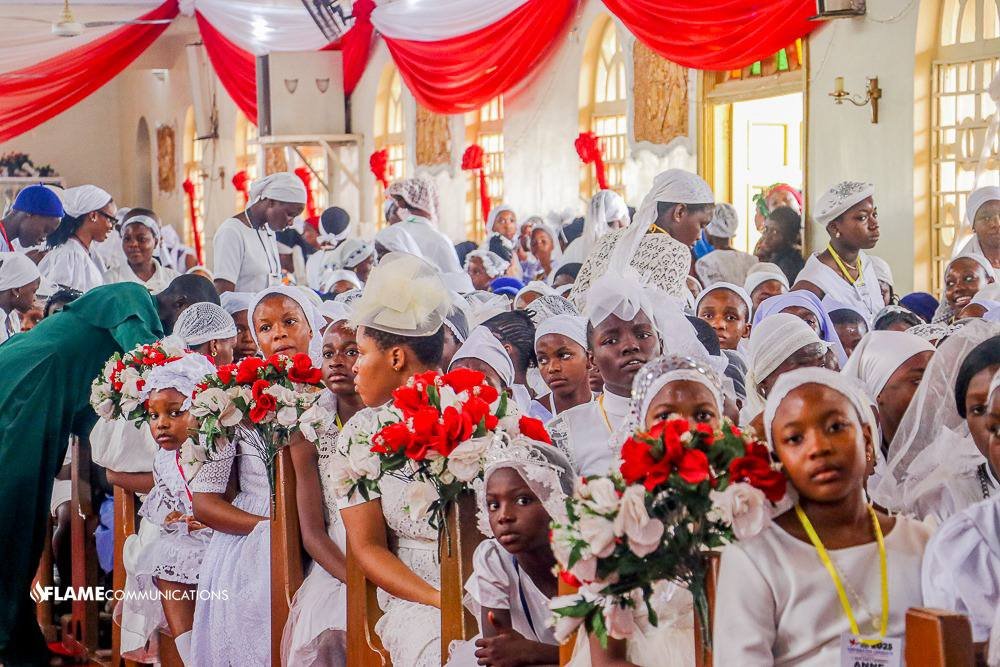 Auxiliary Bishop Ernest Obodo of Enugu, in the southeastern part of Nigeria, confers the sacrament of confirmation on 983 people at the Holy Spirit Cathedral on June 4, 2025. The ceremony included both children and adults, but youth made up the majority. Faith grows in Nigeria amid extreme persecution. Pope Leo prayed for Christians massacred in the country over the June 14-15 weekend. (OSV News photo/courtesy Diocese of Enugu)