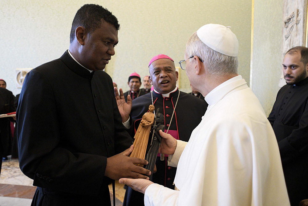 Pope Leo XIV receives a gift during a meeting with bishops from Madagascar visiting Rome for the Holy Year 2025 at the Vatican June 16, 2025. (CNS/Vatican Media)