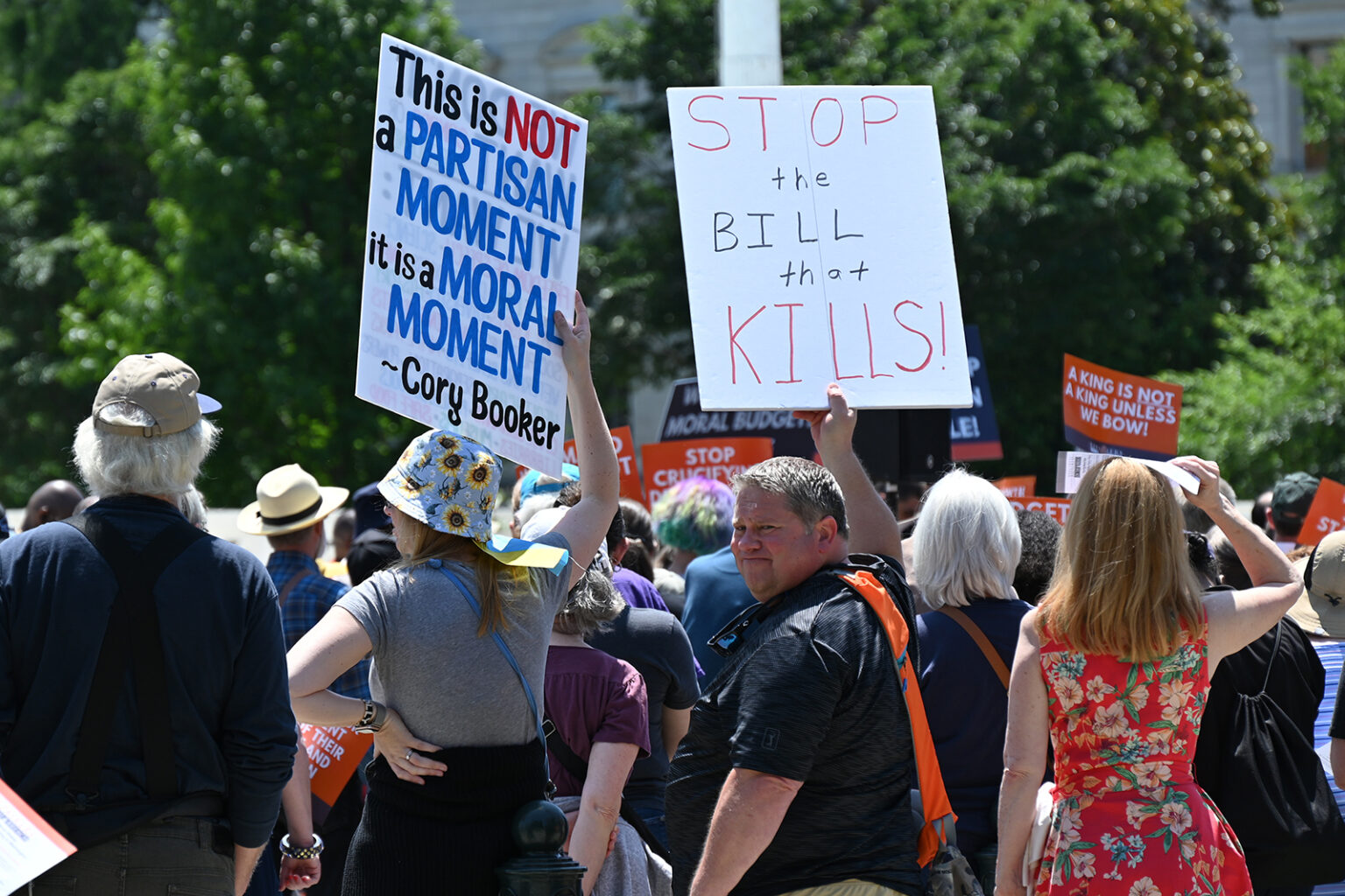 Demonstrators display signs at a Moral Mondays rally outside the U.S. Supreme Court, Monday, June 2, 2025, in Washington. (RNS/Jack Jenkins)