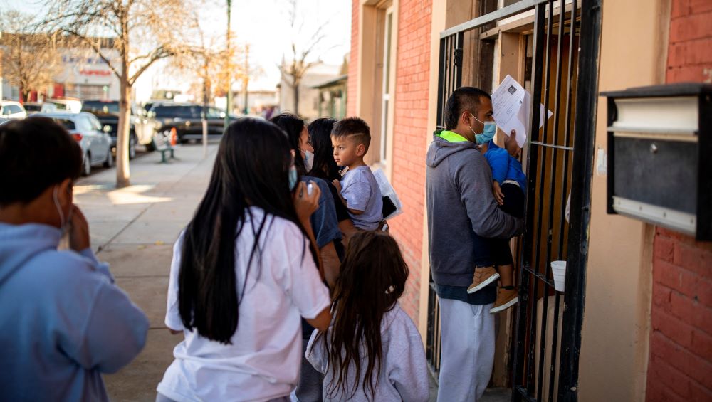 A migrant family is dropped off Dec. 13, 2022, at a migrant shelter run by the Annunciation House in downtown El Paso, Texas. 