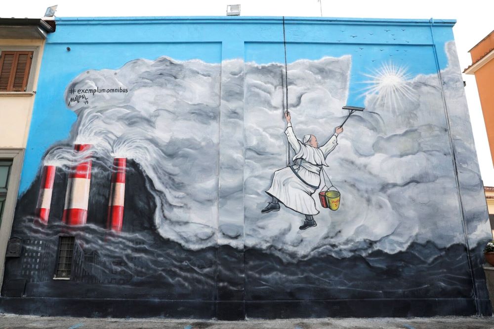 Pope Francis cleans the sky of pollution in graffiti by the artist Maupal, inspired by "Laudato Si'." (AP/Andrew Medichini)