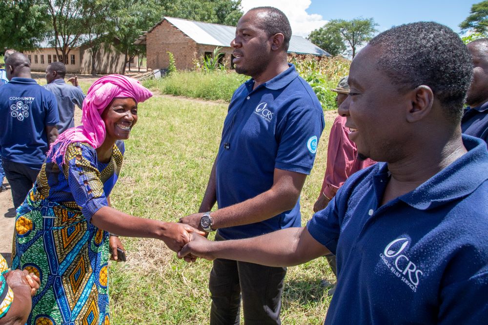 A village woman greets a Catholic Relief Services worker in Tanzania.