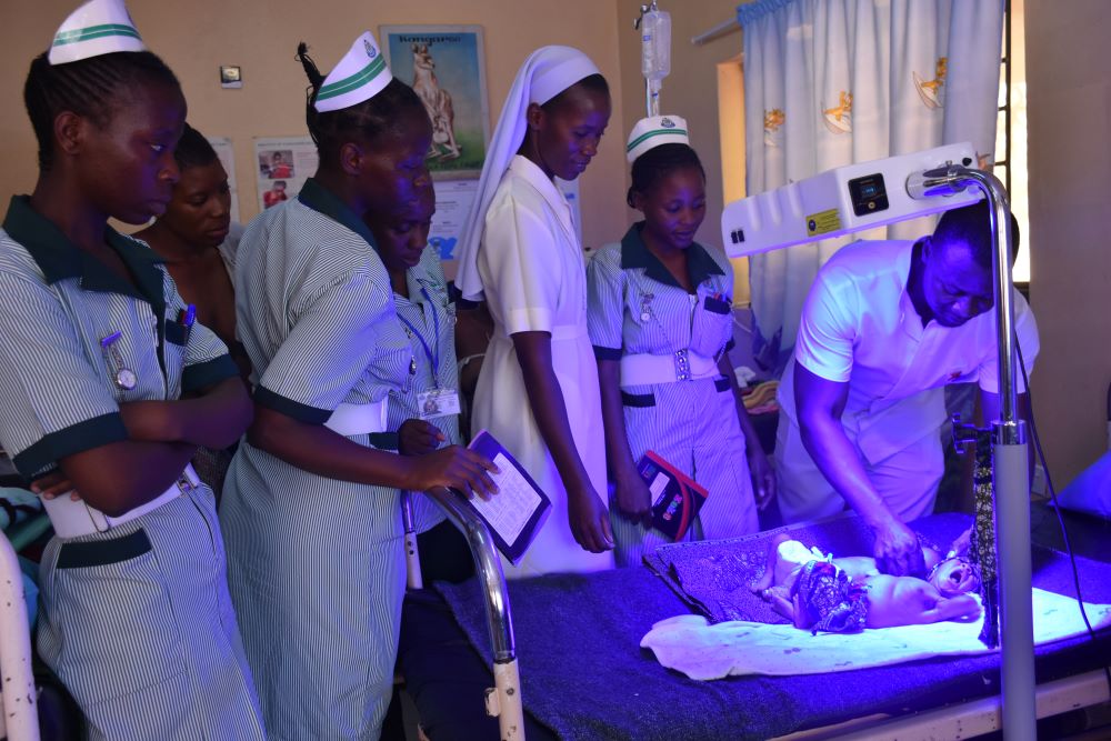 Sr. Joyce Miyanda (center), flanked by health care workers, inspects the neonatal ward at Monze Mission Hospital. 
