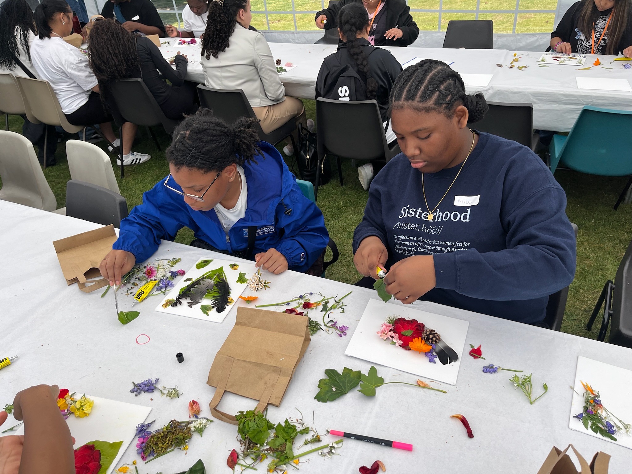 Aziza Walker and Makayla Broadwater assemble their artistic creations during the "Finding God in a Leaf" retreat exercise at the Convent of Jesus and Mary