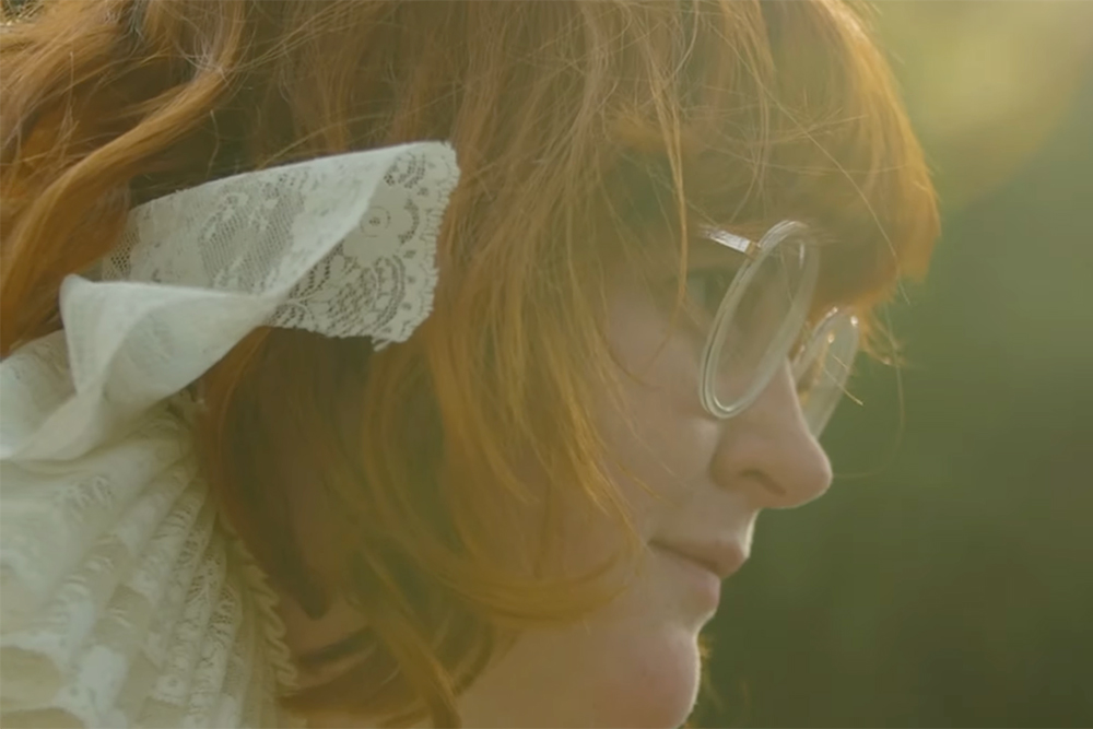 Raised Catholic, the musician Corook explores queerness and self-acceptance in their new album, "Committed to a Bit." (NCR screenshot/YouTube/hicorook)
