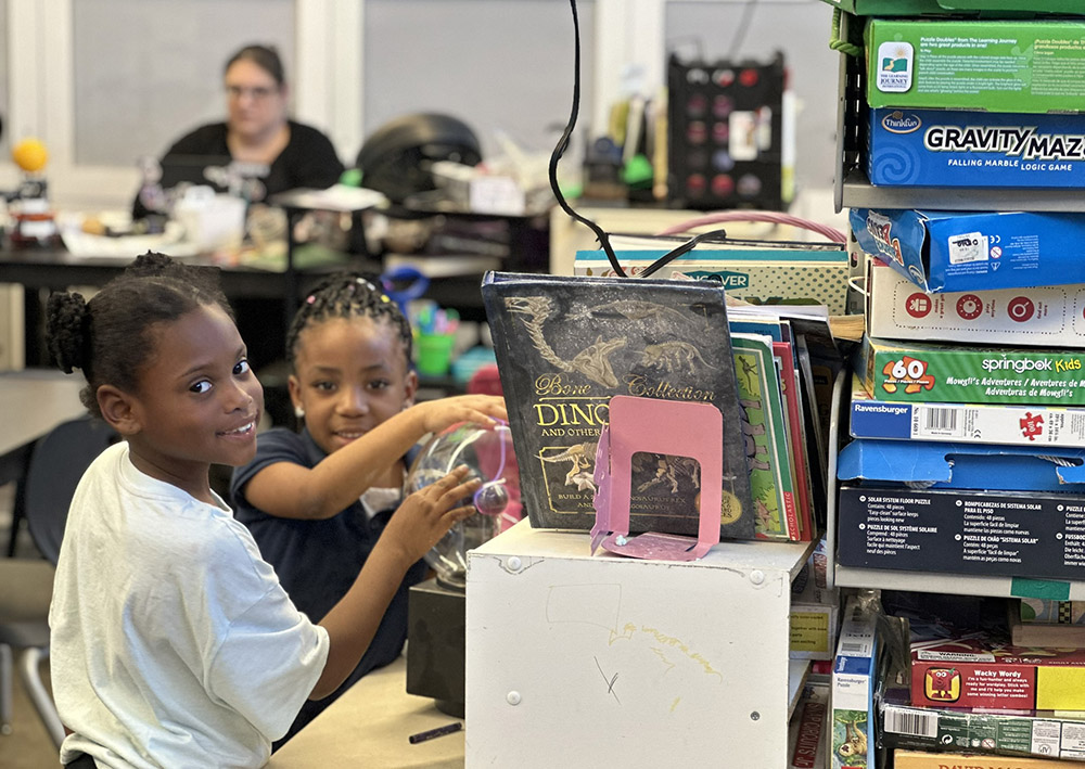 A 6- and 7-year old spend afterschool hours in the Science Room engaging in hands-on experiments. (GSR photo/Soli Salgado)