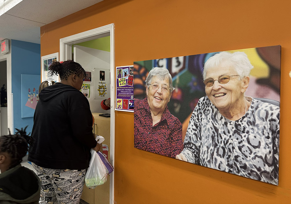 A portrait of Srs. Corita Bussanmas and Berta Sailer hangs next to the Operation Breakthrough food pantry. (GSR photo/Soli Salgado)