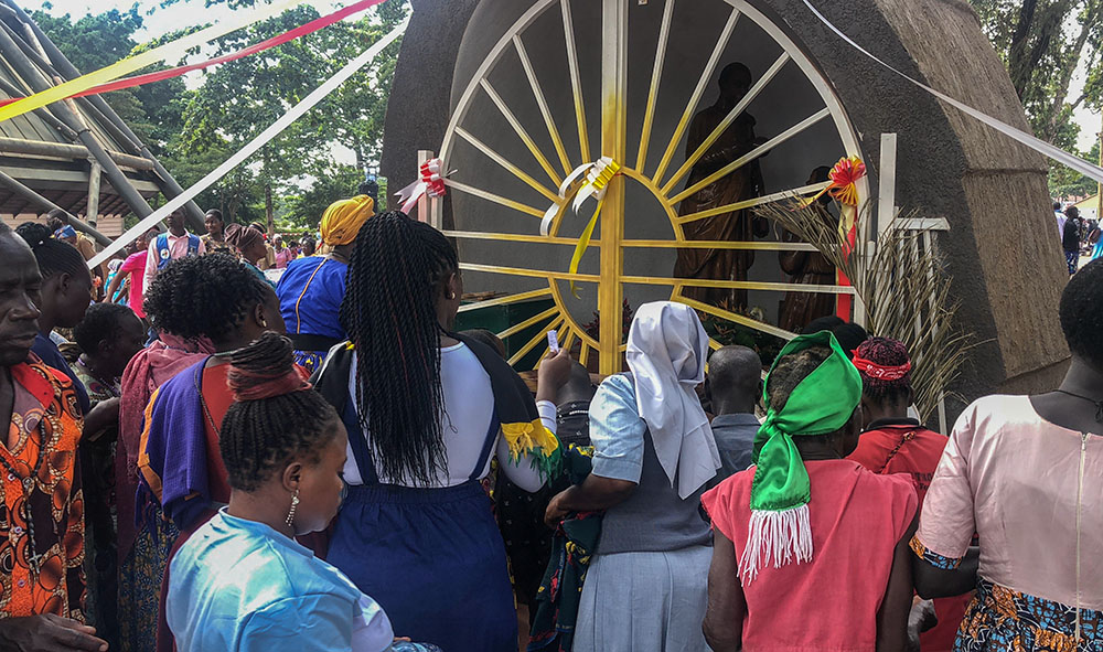 Pilgrims crowd around the gated shrine at Namugongo, quietly offering personal intentions. The pilgrimage site remains a place of deep devotion, attracting Christians from across East Africa who come to honor the memory of the 22 Catholic martyrs canonized by Pope Paul VI in 1964. (GSR photo/Gerald Matembu)