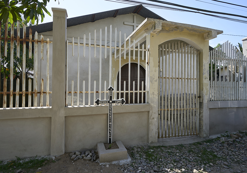In front of a small Catholic church in the Fabio Ochoa neighborhood of Tocoa, Honduras, a cross marks the spot where Juan López, a Catholic delegate of the word, was assassinated on Sept. 14, 2024. López had just finished leading a celebration of the word in the church. (NCR photo/Paul Jeffrey)