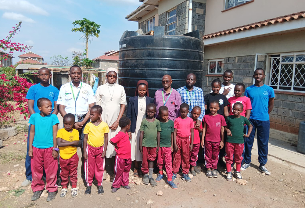 Little Sisters of St. Joseph and their students pose for a photo with Kenya Commercial Bank employees. The bank donated a 6,000-liter water tank to the school in March 2024 as part of their initiative to help schools in dry areas access clean drinking water. (Courtesy of Sr. Rose Bonareri)