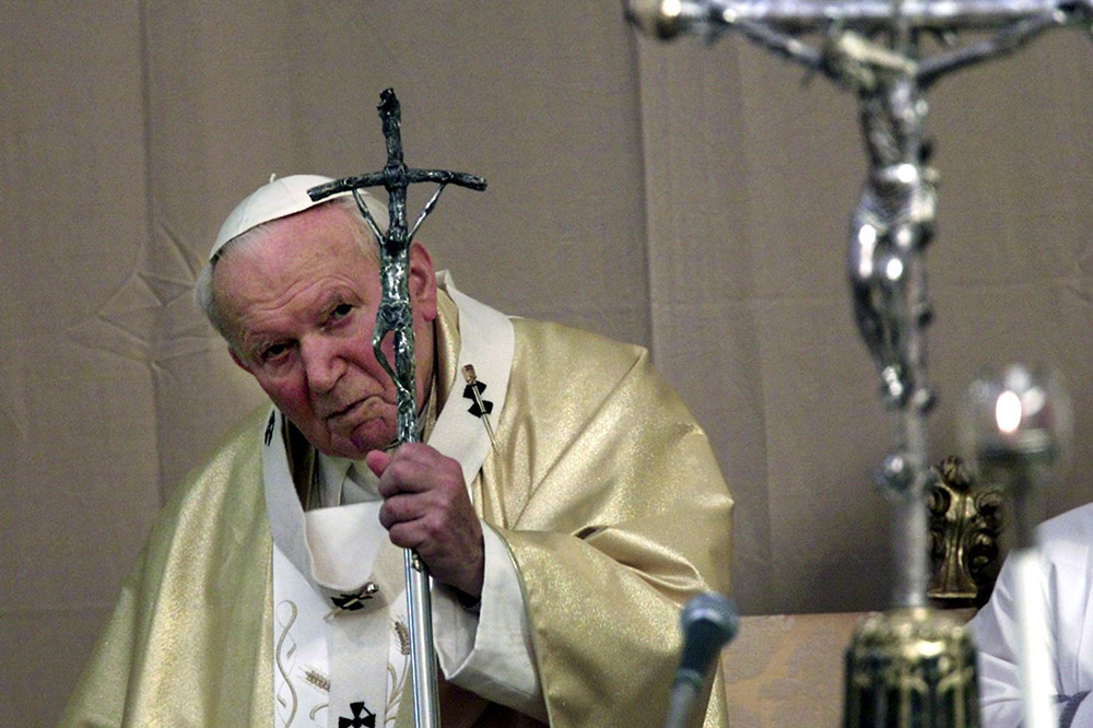 Pope John Paul II celebrates Mass on the feast of the Assumption Aug. 15, 2001, in a courtyard of the papal summer residence in Castel Gandolfo, Italy. (CNS/Reuters)