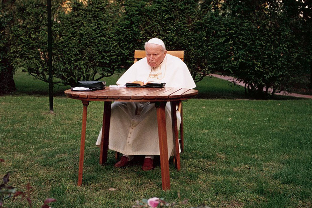 Pope John Paul II prays in the garden at his summer residence of Castel Gandolfo, Italy, Sept. 19, 2004. (CNS/L'Osservatore Romano)
