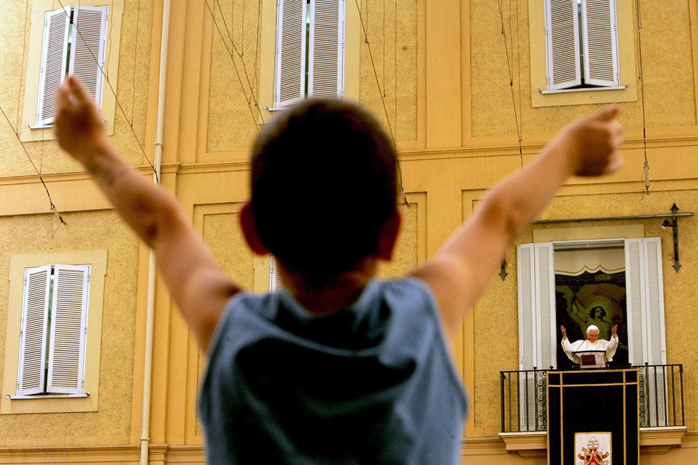 Pope Benedict XVI waves to the faithful gathered for recitation of the Angelus at the pontiff's summer residence in Castel Gandolfo, Italy, Aug. 20, 2006. (CNS/Reuters/Dario Pignatelli) 