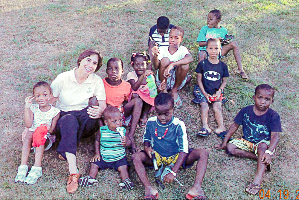 Holy Family of Nazareth Sr. Linda Yankoski is pictured with children from Haiti at the Holy Family Institute in Pittsburgh in 2010. (Courtesy of Holy Family Institute)