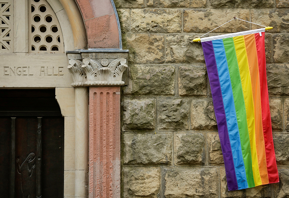 A rainbow flag is seen on the wall of a Catholic church in Cologne, Germany, May 10, 2021, as the building is open for same-sex couples to receive a blessing. Pope Francis formally approved letting Catholic priests bless couples in same-sex relationships, the Vatican announced Dec. 18, 2023. (OSV News/Reuters/Thilo Schmuelgen)