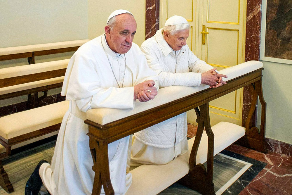 Pope Francis prays with retired Pope Benedict XVI at the papal summer residence in Castel Gandolfo, Italy, March 23, 2013. (OSV News/Vatican Media via Reuters)