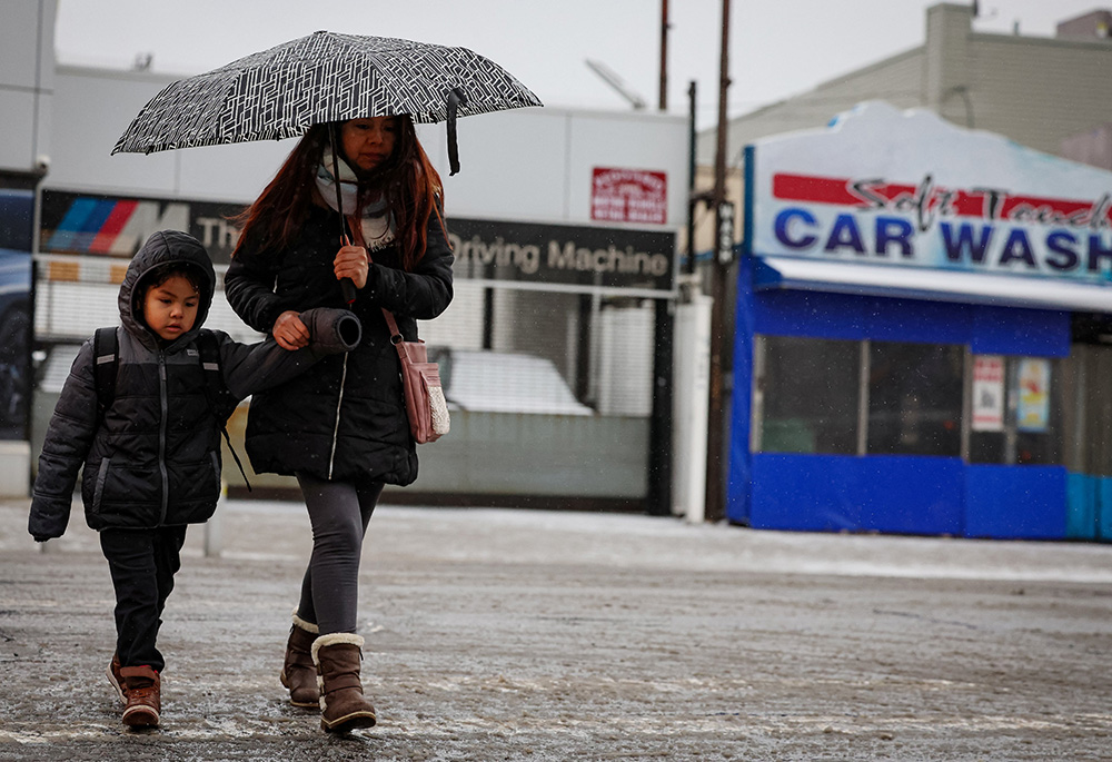 A mother and child walk to school during a morning snowfall in the Brooklyn borough of New York City, on Feb. 6, 2025. (OSV News/Reuters/Brendan McDermid)