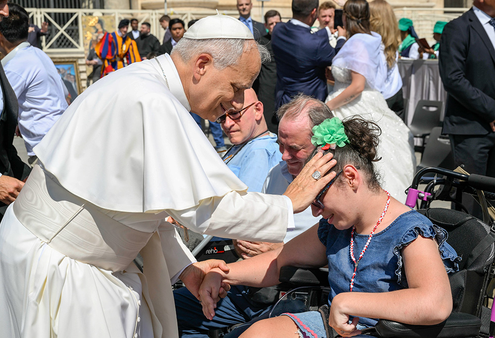 Pope Leo XIV blesses a young woman in St. Peter's Square at the Vatican before his weekly general audience June 25, 2025. (CNS/Vatican Media)