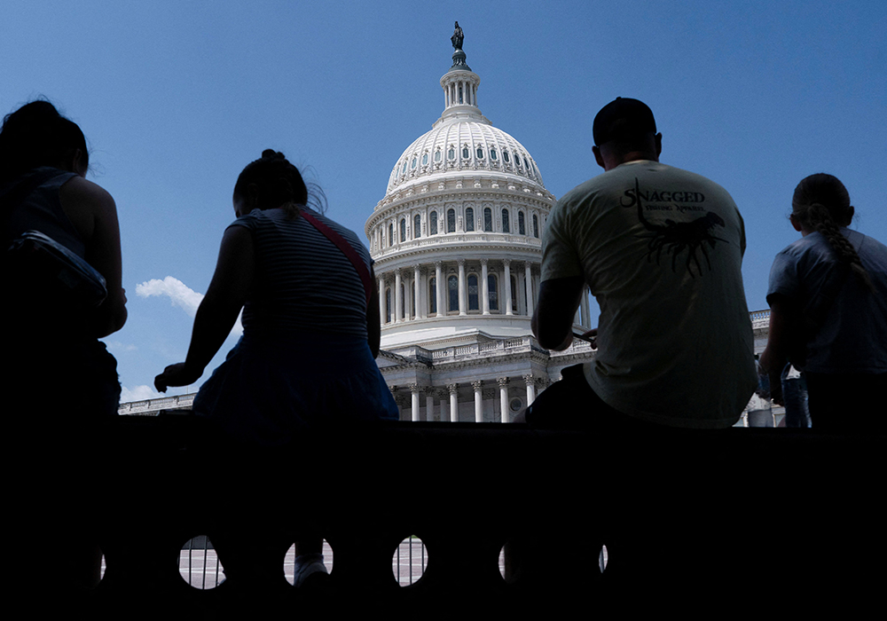 Visitors to the U.S. Capitol rest in the shade on Capitol Hill in Washington on June 25, 2025. (OSV News/Reuters/Nathan Howard)