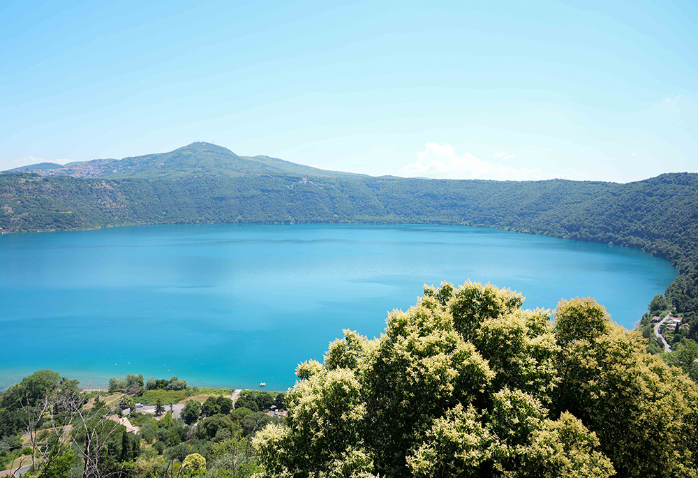 Lake Albano, which formed inside a volcano, is seen from Castel Gandolfo, Italy, on July 1, 2025. Pope Leo XIV will use a new formulary for a private Mass July 9 with the staff of the Borgo Laudato Si' ecology project, a space for education and training in integral ecology hosted in the gardens of the papal villa at Castel Gandolfo. (CNS/Lola Gomez)