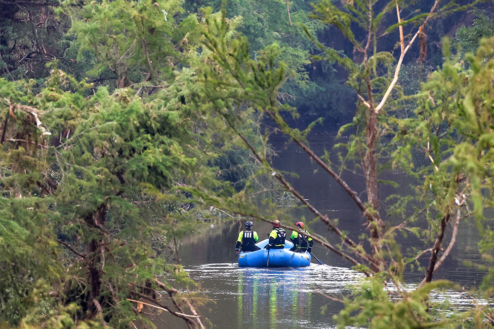 Rescuers paddle an inflatable boat as they search along a waterway in the aftermath of deadly flooding in Kerrville, Texas, July 6, 2025. (OSV News/Reuters/Marco Bello)