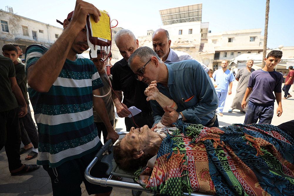 A wounded Palestinian Christian woman is brought into Al-Ahli Arab Baptist Hospital following what initial reports and medics say was an Israeli tank attack on the church on the Holy Family Parish — the only Catholic parish in the Gaza Strip, in Gaza City July 17, 2025. (OSV News/Reuters/Dawoud Abu Alkas)