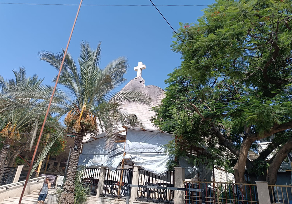 Damage can be seen next to the cross on the roof of the Holy Family Church in Gaza after it was hit in an attack July 17, 2025. Three people died and another 10 were injured, including the parish priest, Father Gabriel Romanelli, who sustained a slight injury to his right leg. (CNS/Courtesy of Aid to the Church in Need, UK)