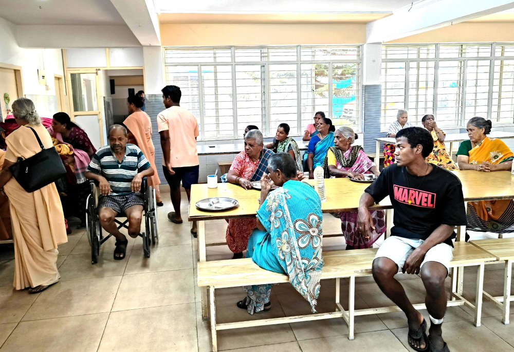 Residents of Sumanahalli, Bengaluru, southern India, assemble for their lunch at the dining hall as the nuns prepare to serve them. (Thomas Scaria)