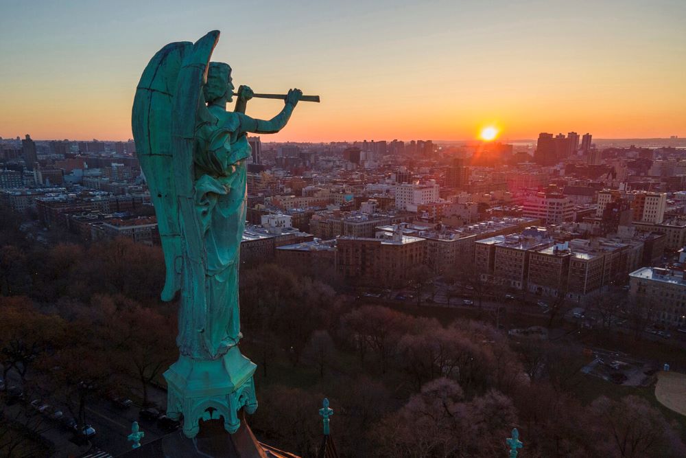 A bronze statue of the archangel Gabriel blowing a trumpet stands atop the Cathedral of St. John the Divine in N.Y. A bronze statue of the archangel Gabriel blowing a trumpet stands atop the Cathedral of St. John the Divine in N.Y.