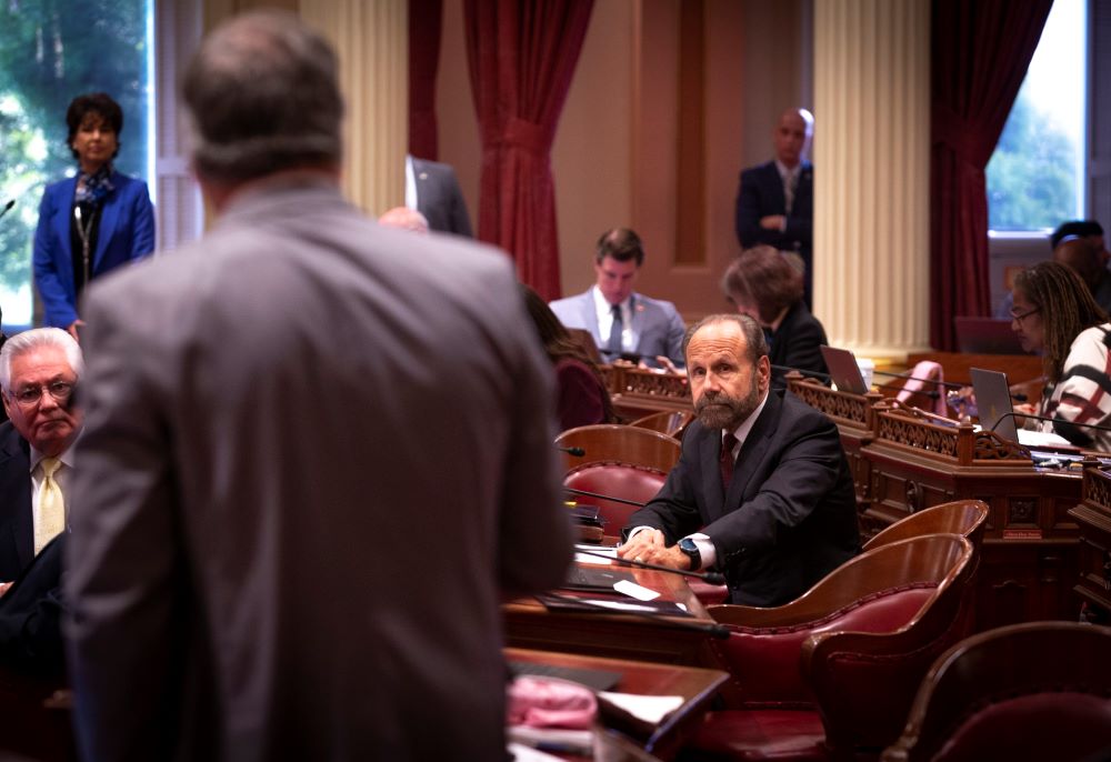 California state Sen. Jerry Hill speaks with another state legislator at the California Capitol in Sacramento May 9, 2019. 