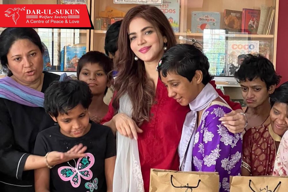 Humaira Asghar poses with children at Dar-ul-Sukun, Karachi, Pakistan.