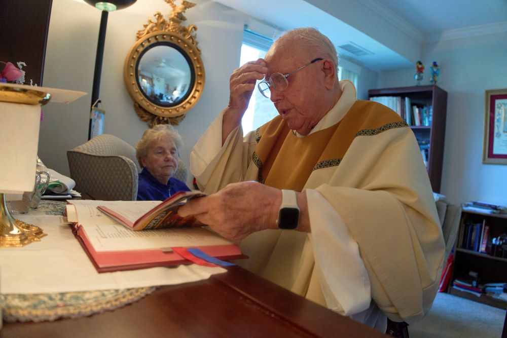Fr. James Kelly celebrates Mass at his apartment. Fr. James Kelly celebrates Mass at his apartment.