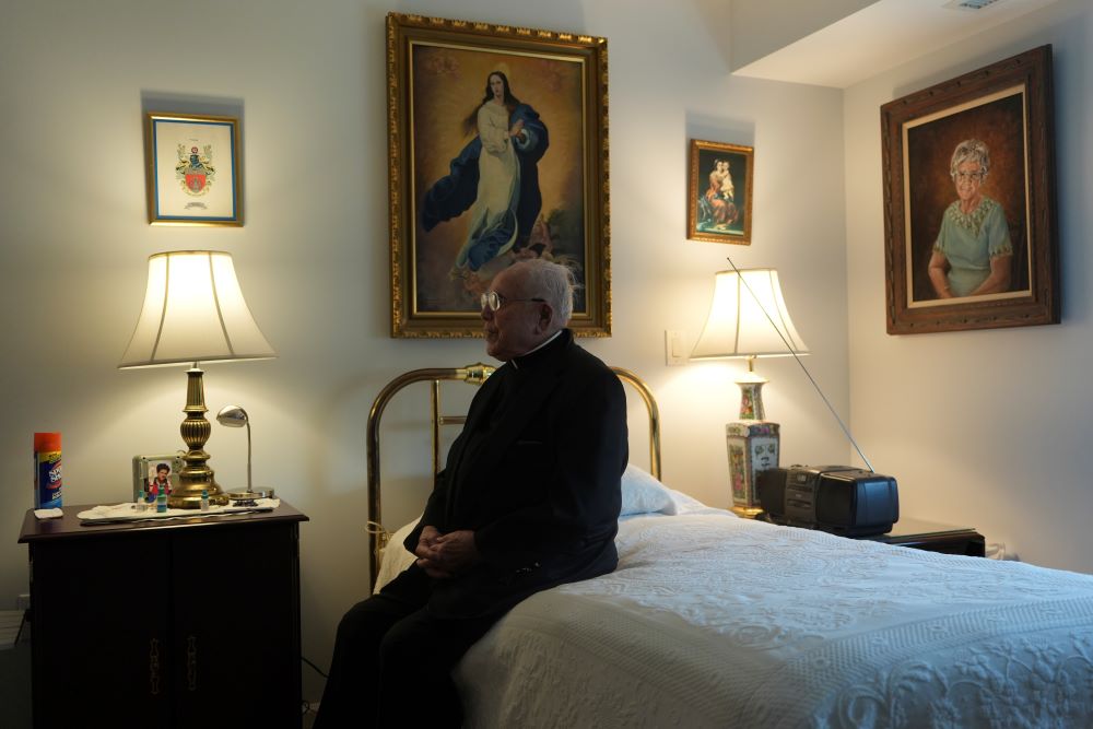 Fr. James Kelly sits in his apartment. Fr. James Kelly sits in his apartment.
